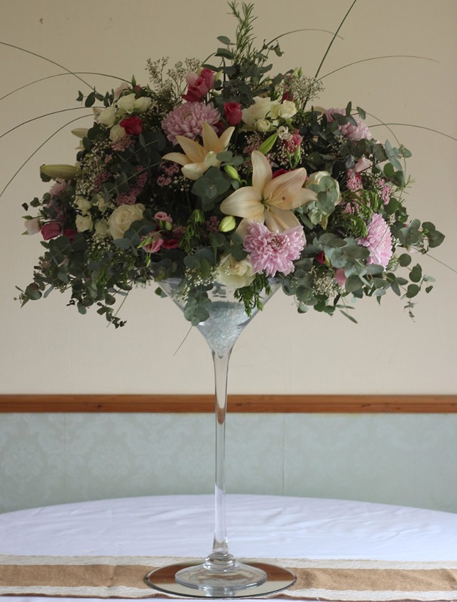 Cocktail glass display with lilies