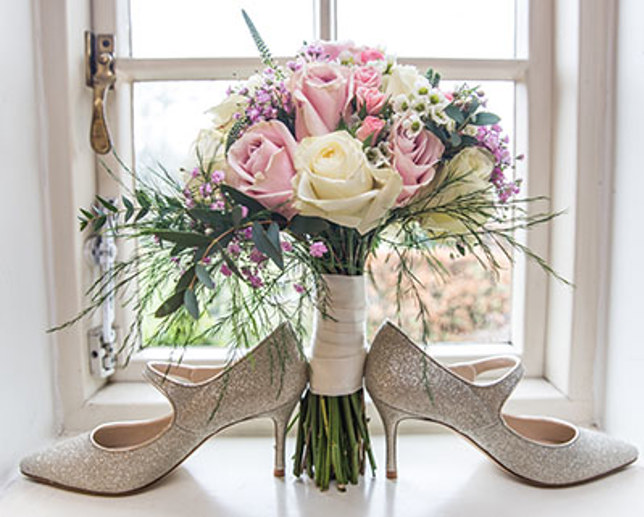 Blush pink wedding bouquet with greens